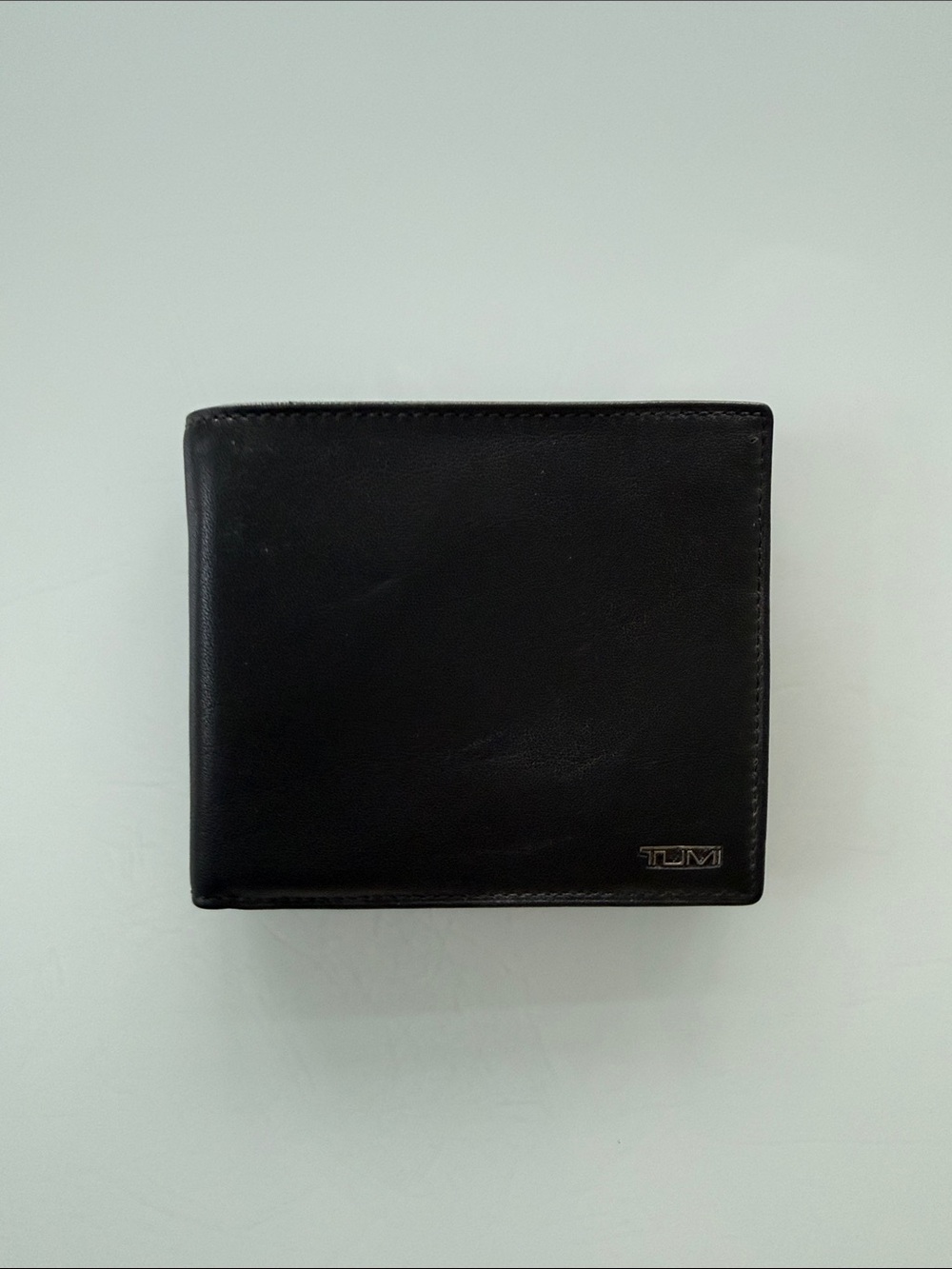 Tumi Black Leather Fold Wallet with Metal Logo
